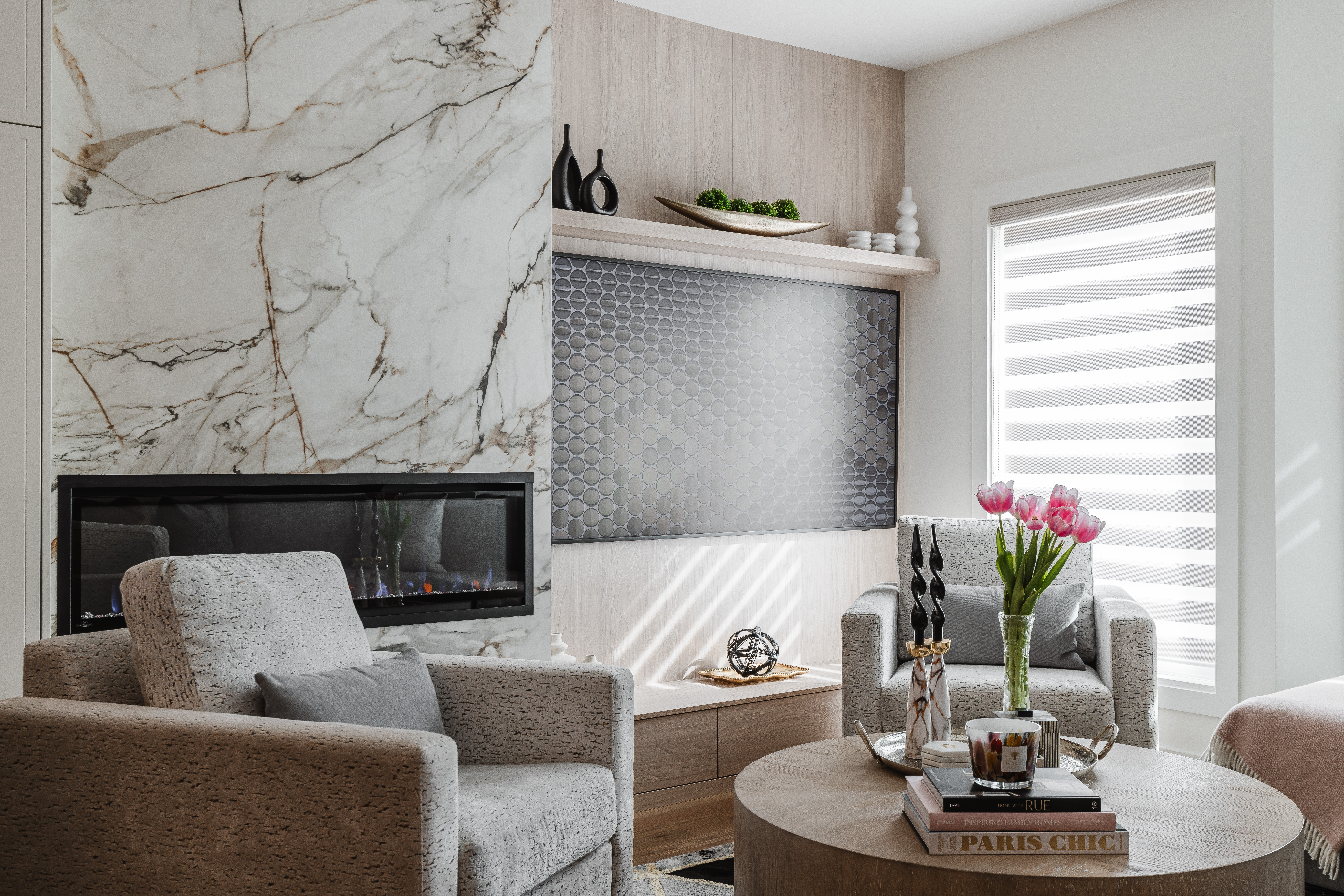 Experience comfort in this modern living room featuring a sleek fireplace, plush seating, and elegant decor for a cozy atmosphere.