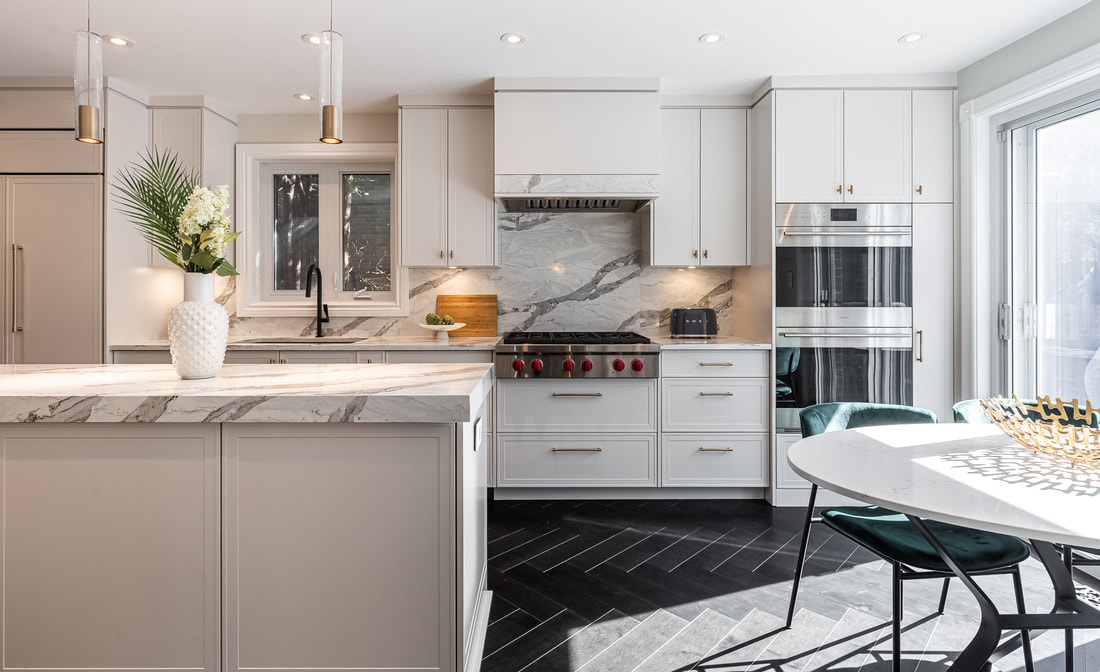 Stylish modern kitchen with elegant stone countertops and a vibrant teal dining area, filled with natural light for a welcoming ambiance.