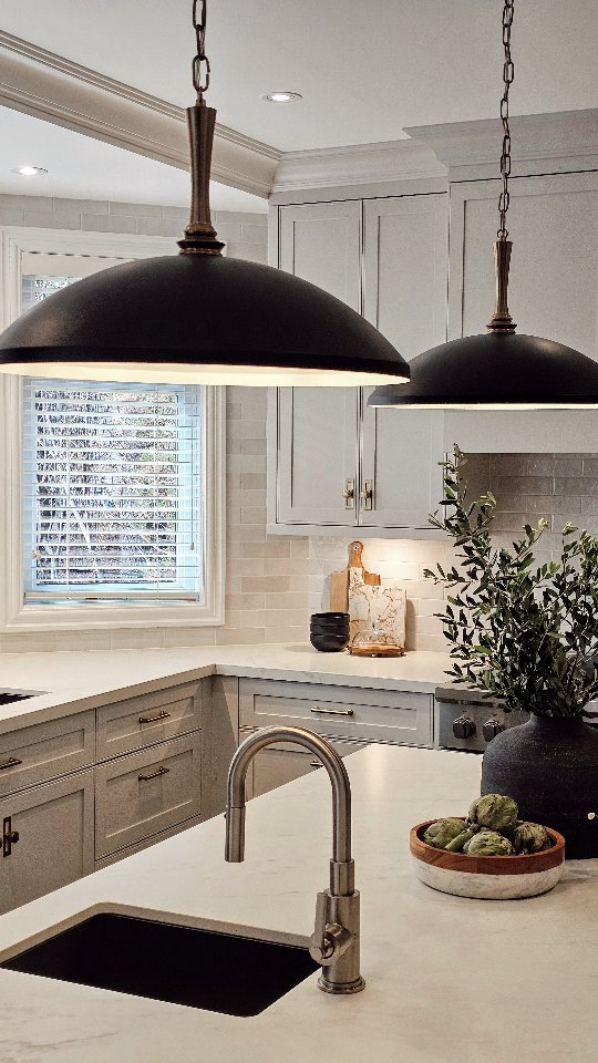 This elegantly designed kitchen combines modern touches with classic elements, filled with natural light and charming details for a welcoming space.
