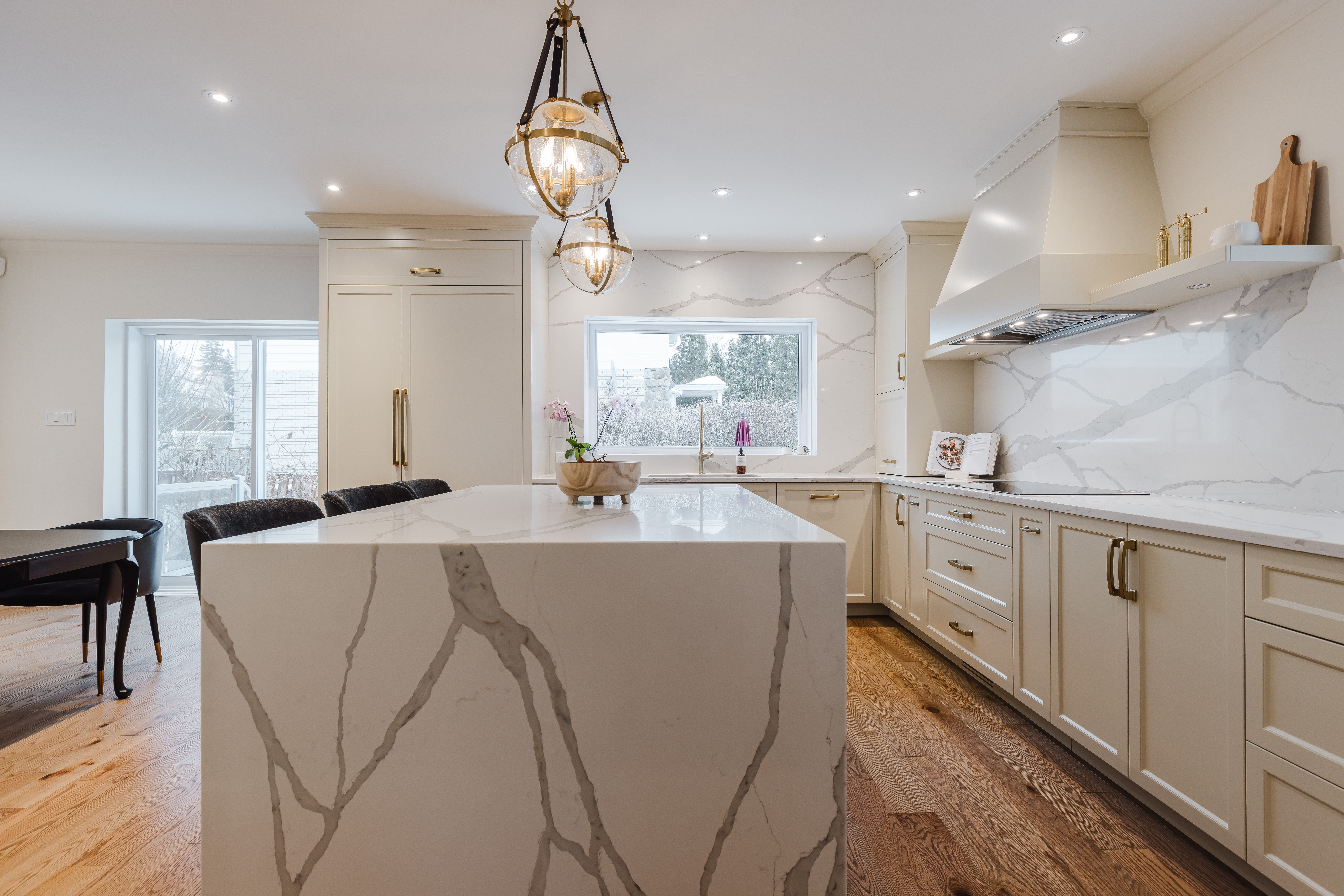 Experience elegance in this modern kitchen featuring a chic island, warm lighting, and a welcoming atmosphere for cooking and gatherings.
