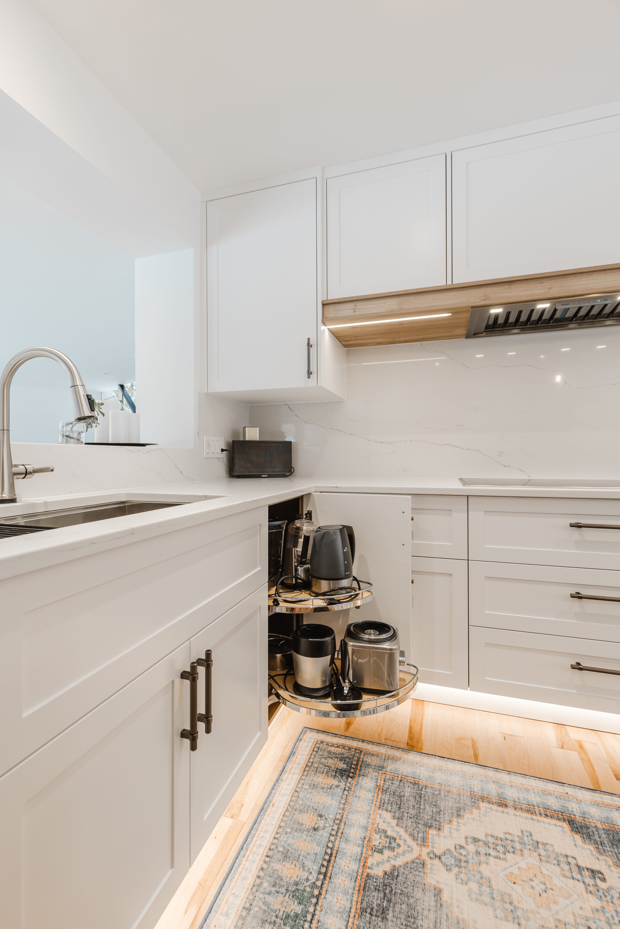 Bright and modern kitchen featuring sleek white cabinetry, polished countertops, and stylish appliances for a welcoming cooking experience.