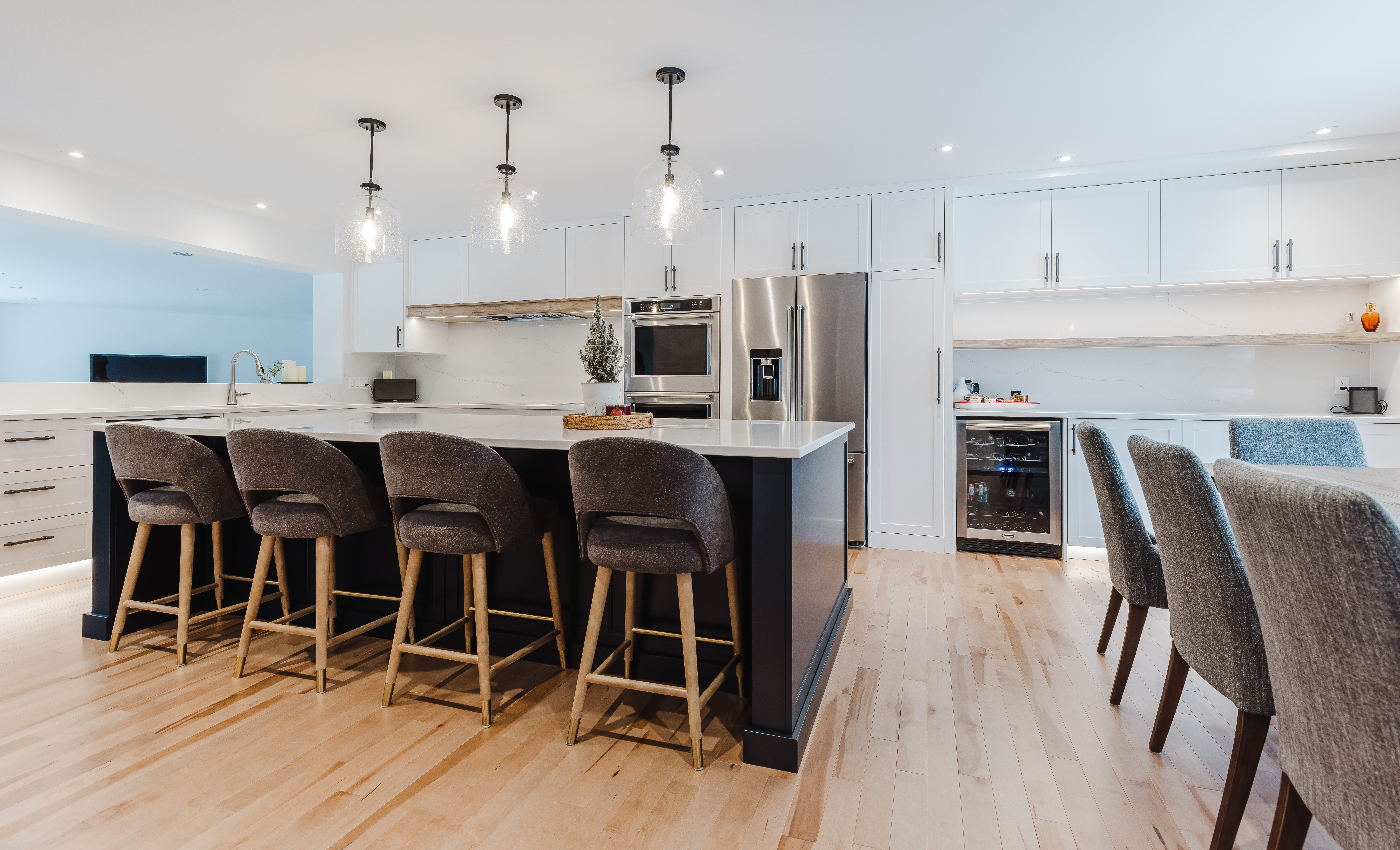 Contemporary kitchen featuring a stylish island with a white countertop, minimalist cabinetry, and abundant natural light for an inviting vibe.