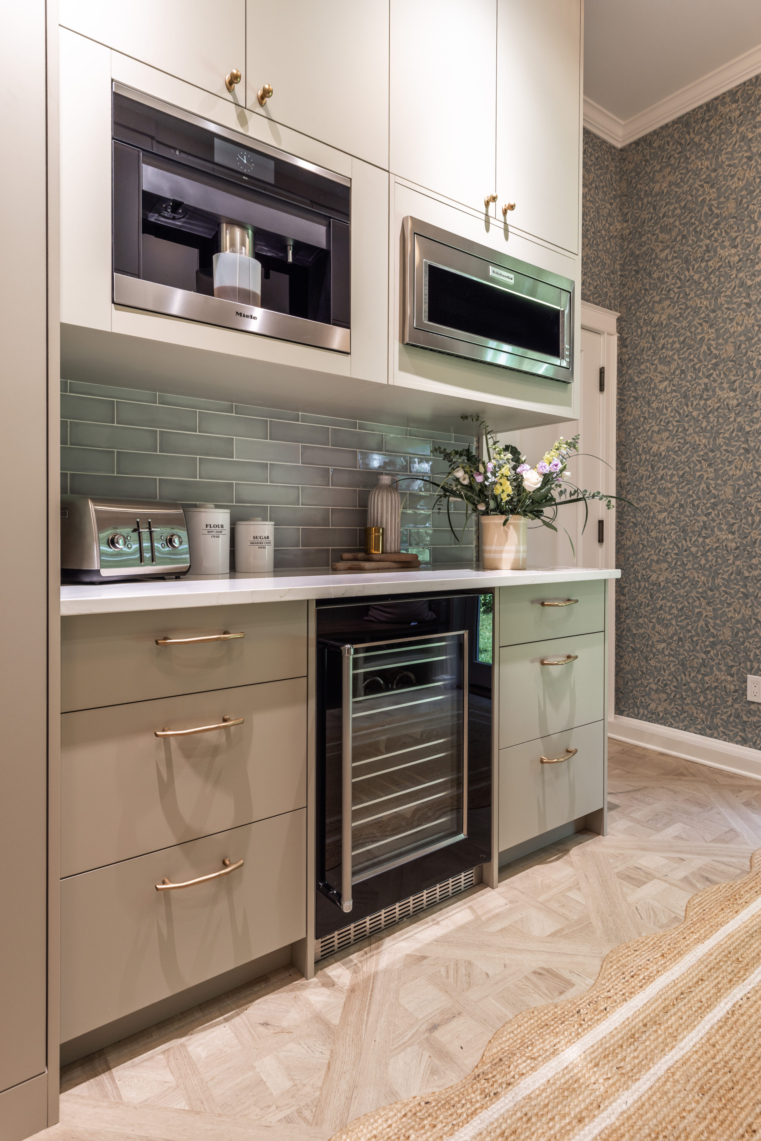 Discover a modern kitchen with soft taupe cabinetry, built-in microwaves, and elegant decor that combines functionality and style.