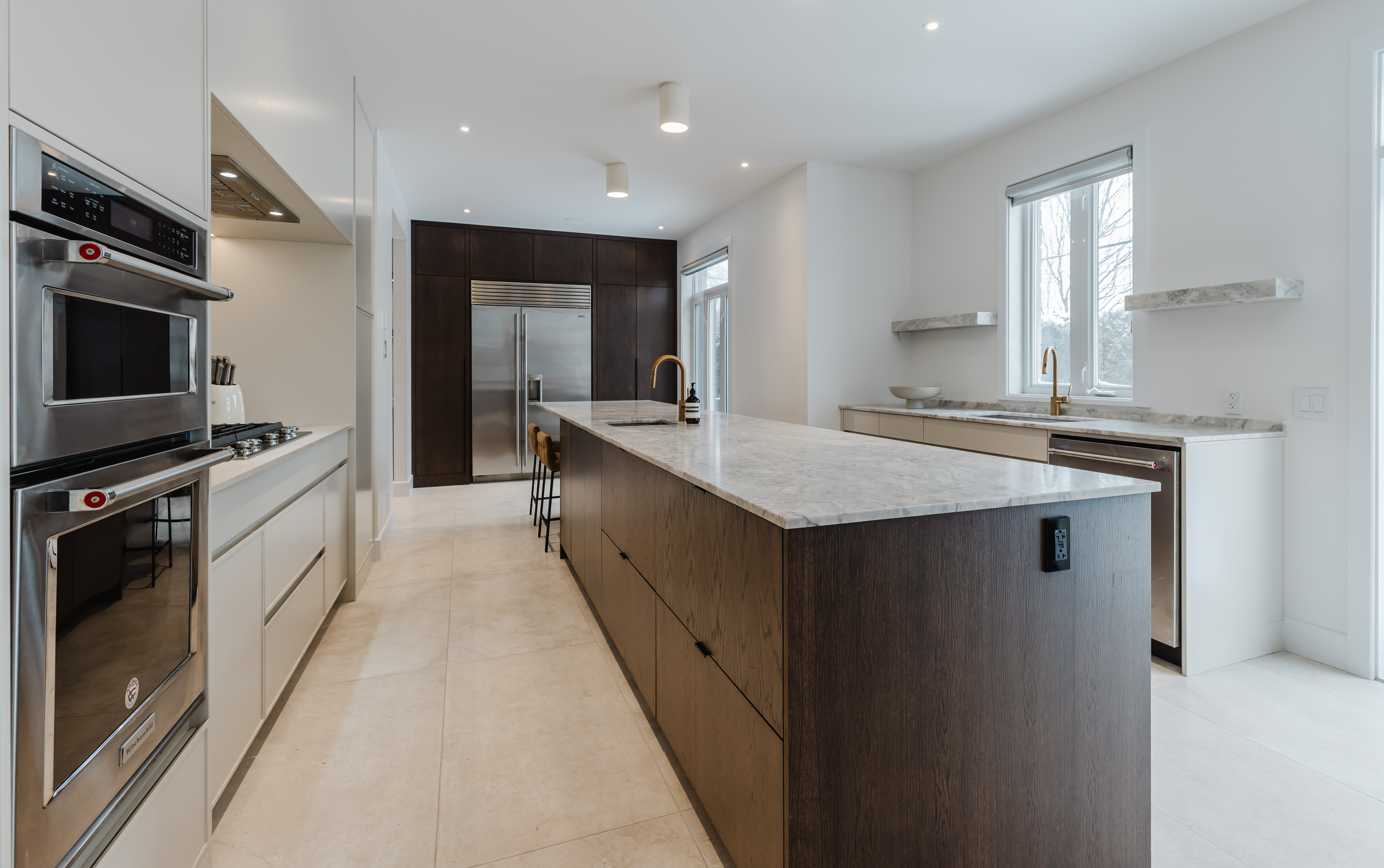 Experience the perfect blend of elegance and functionality in this modern kitchen featuring a spacious central island and abundant natural light.