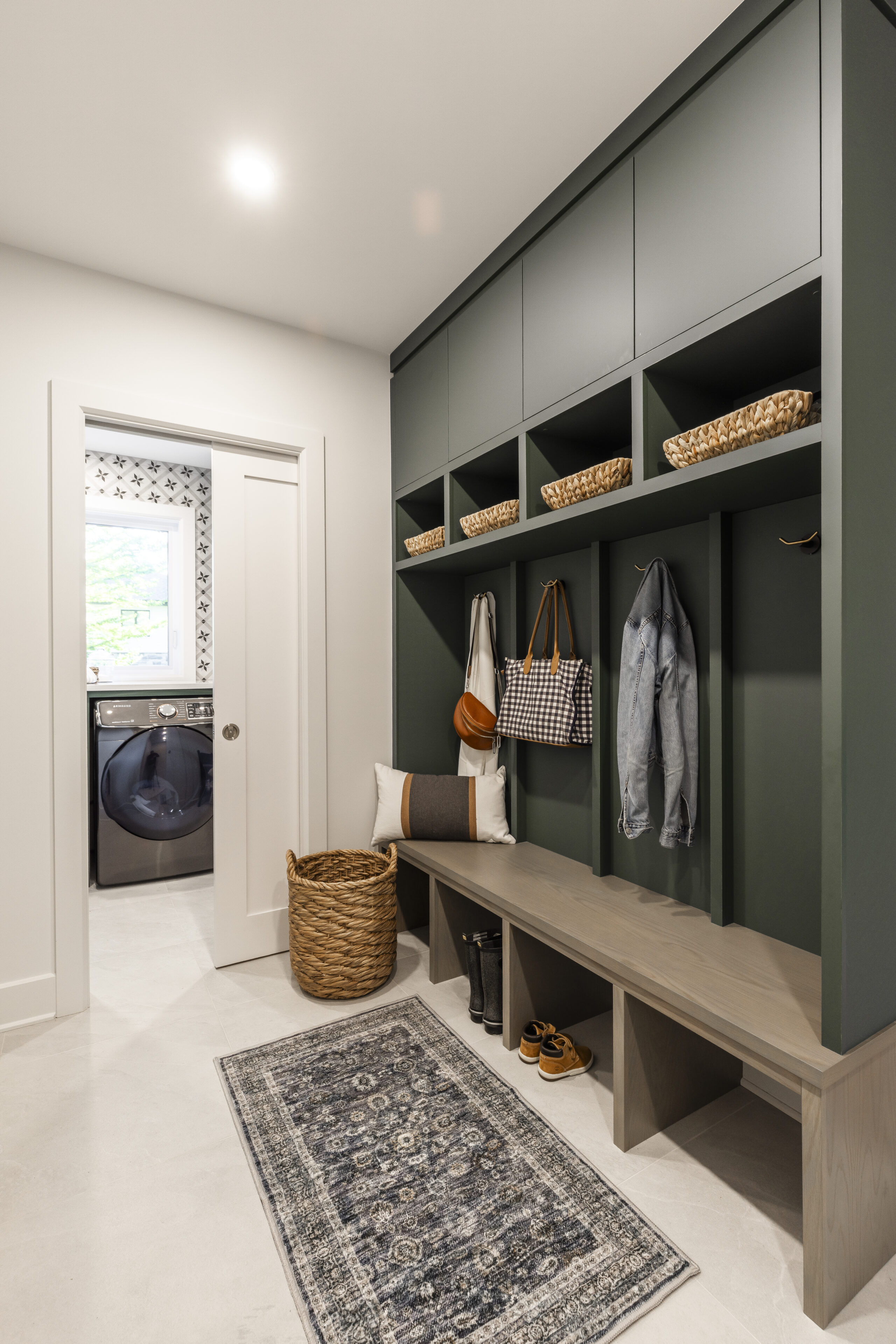 Discover a serene and stylish mudroom featuring a cozy bench, clever storage, and integrated laundry for ultimate convenience and organization.
