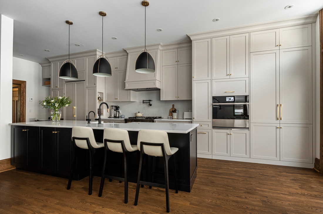 Discover a stylish modern kitchen featuring a cozy island, warm cabinetry, and abundant natural light for an inviting cooking experience.
