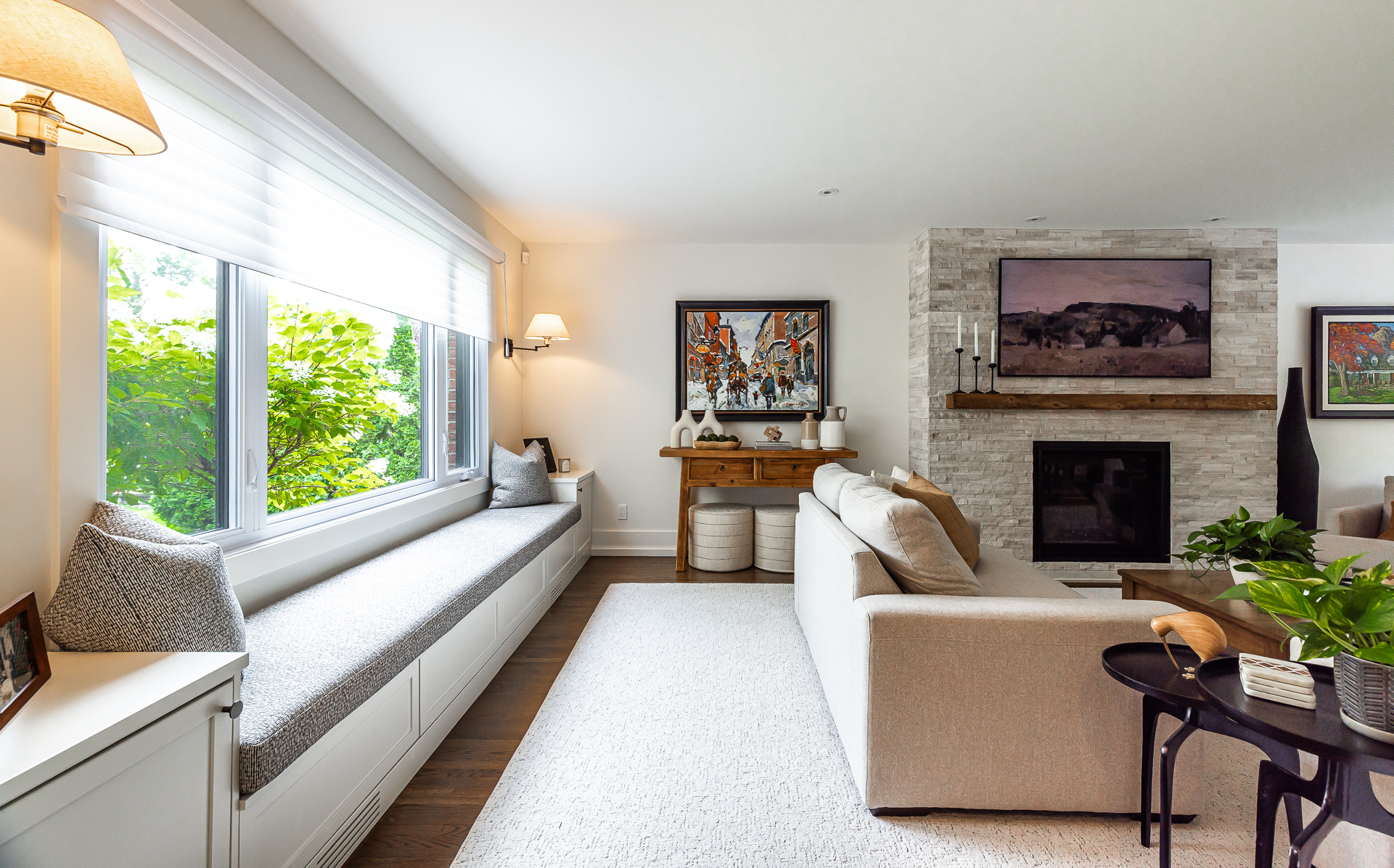 Bright modern living room with natural light, cozy seating, and vibrant art decor.