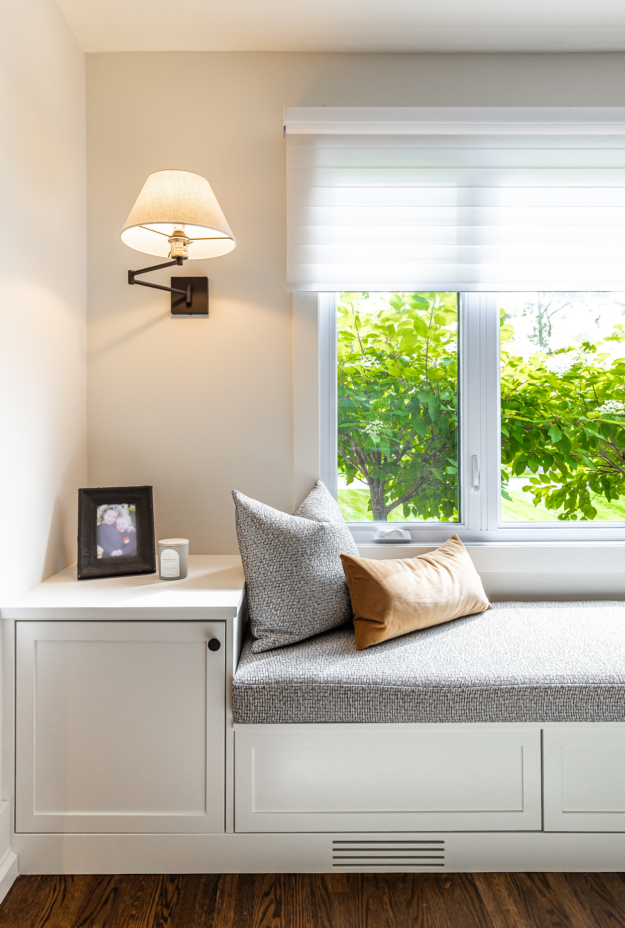 Relax in this cozy window nook featuring plush seating, soft lighting, and tranquil greenery for the ultimate serene escape.