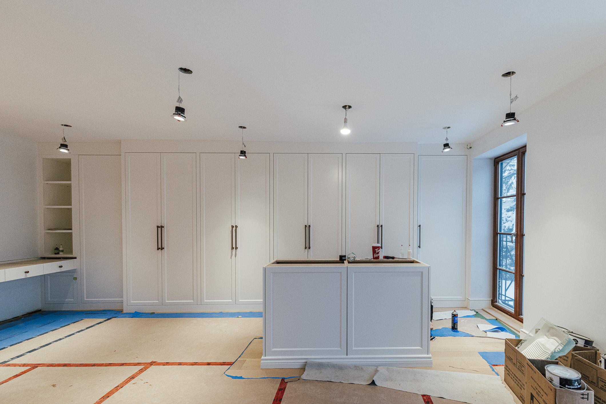 Spacious modern kitchen renovation featuring bright whites and stylish minimalist designs in progress.