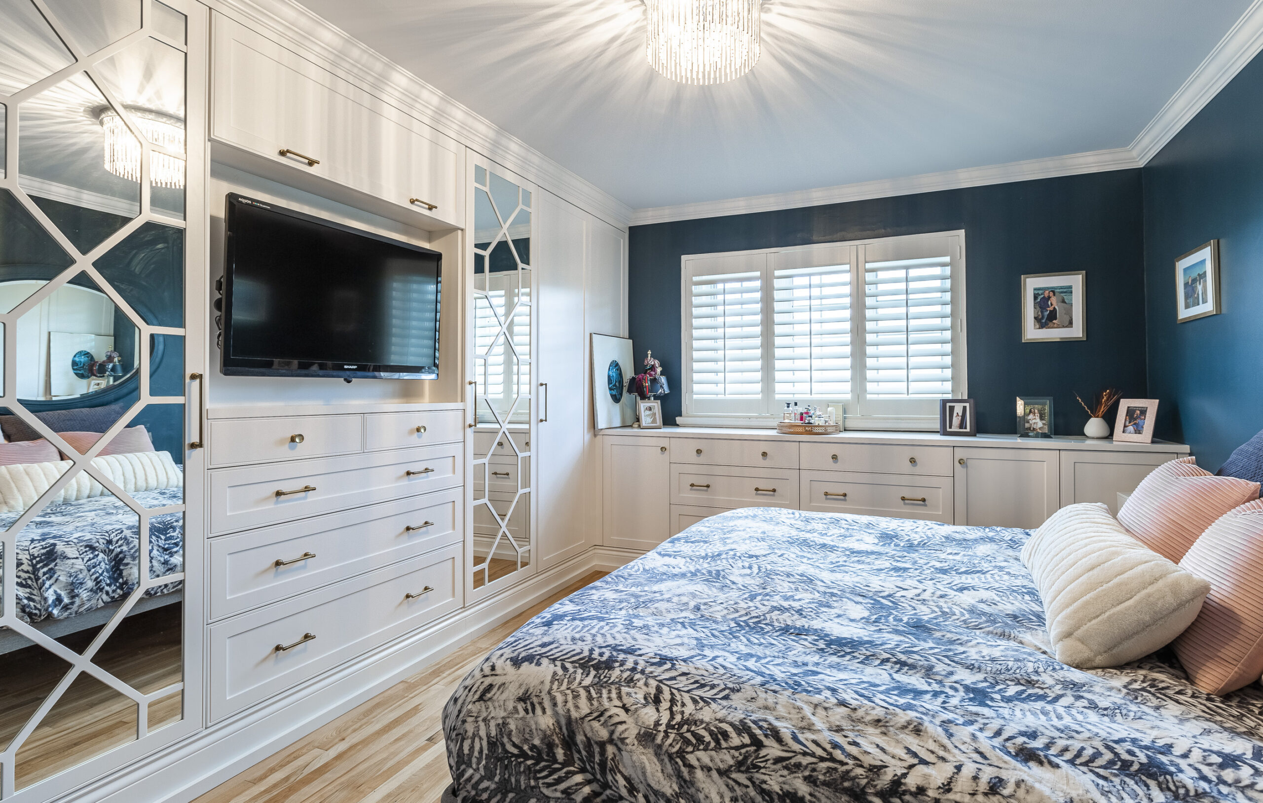 Experience the serene elegance of a modern bedroom featuring plush bedding, soothing blue tones, and inviting decor for the perfect retreat.