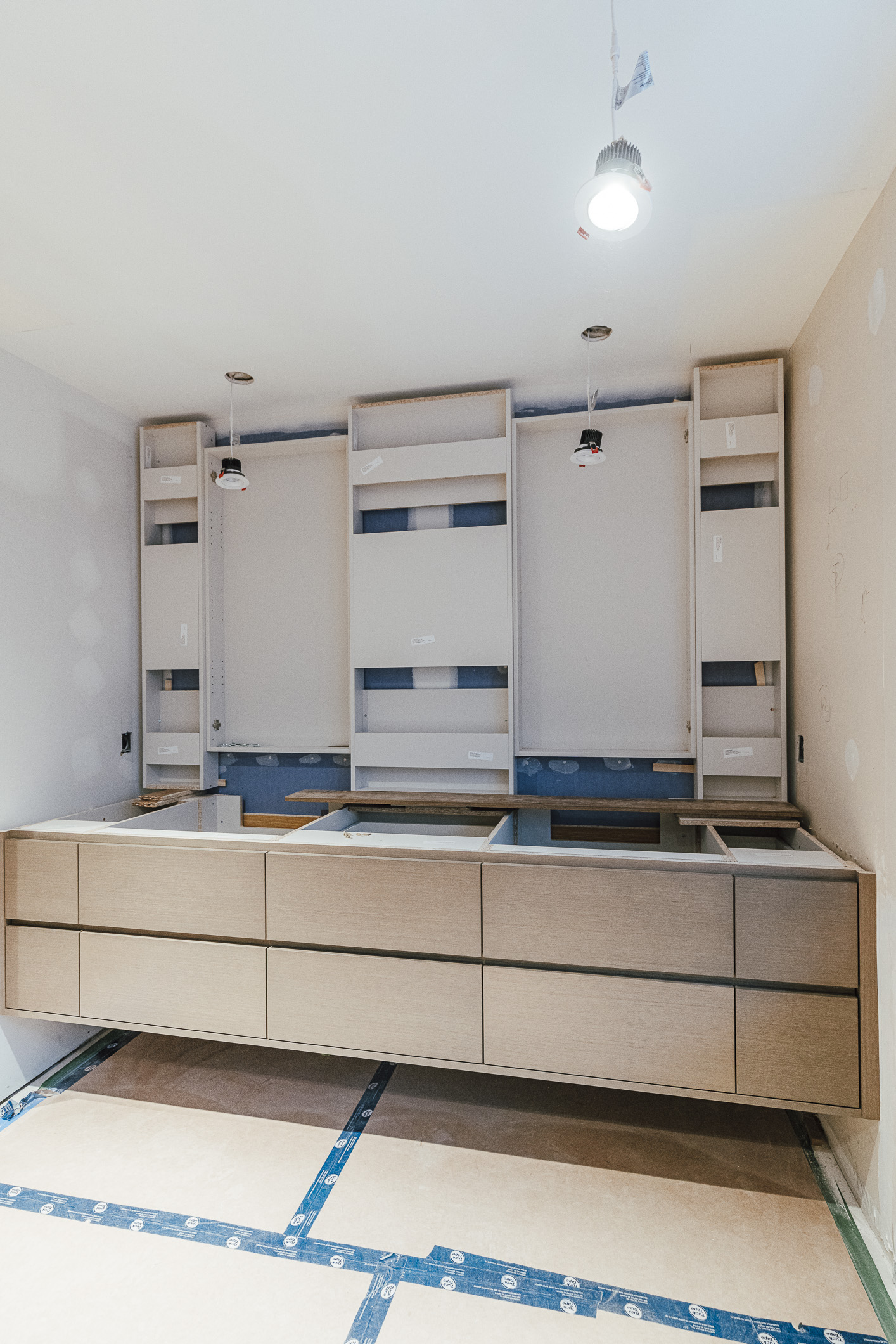Sleek modern cabinetry in a stylish renovation space highlights contemporary design within an unfinished interior.