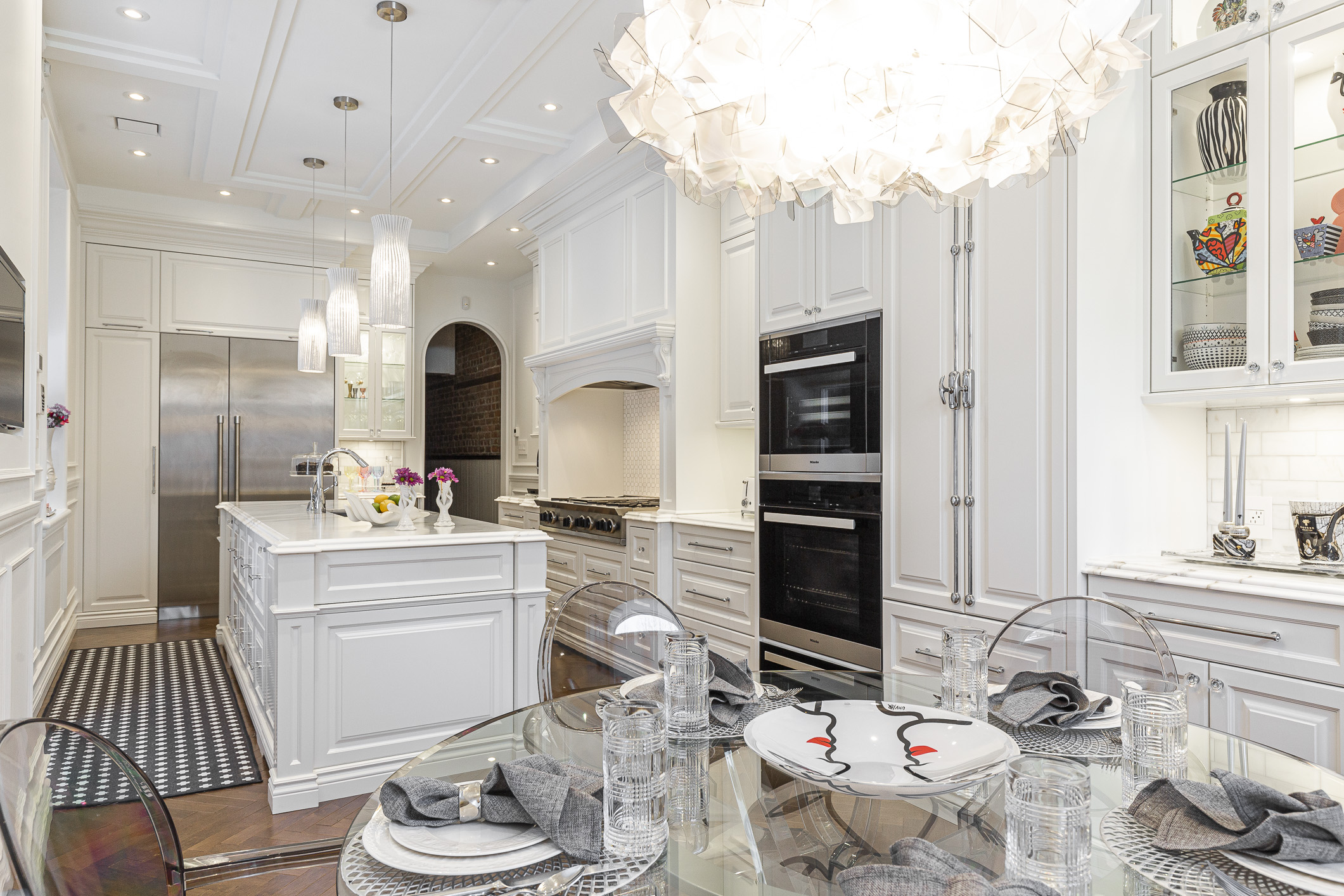 An elegant modern kitchen featuring a spacious island, state-of-the-art appliances, and a chic dining area that invites gatherings.