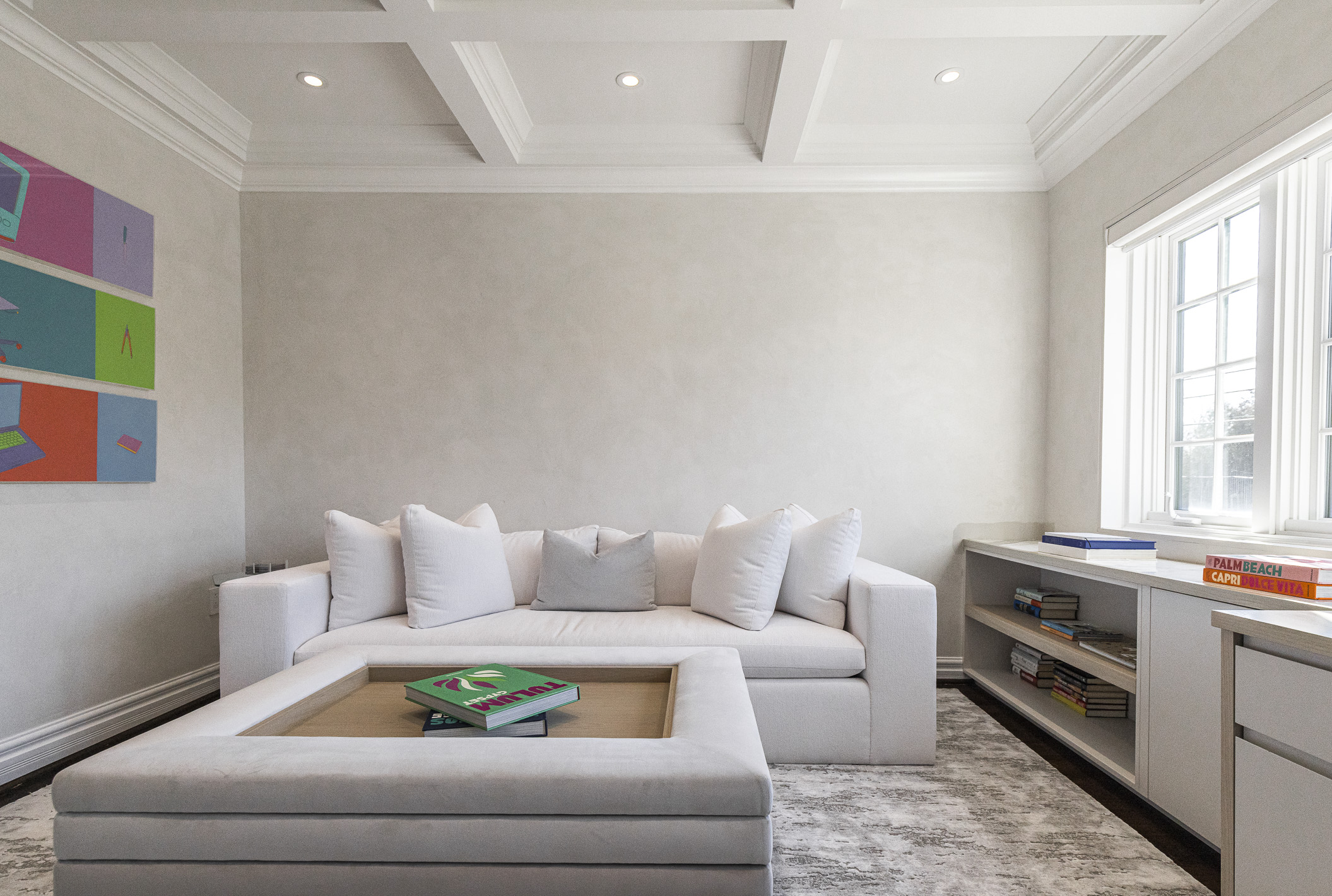 Bright and inviting, this modern living room features a cozy L-shaped couch, stylish decor, and vibrant artwork for a welcoming atmosphere.