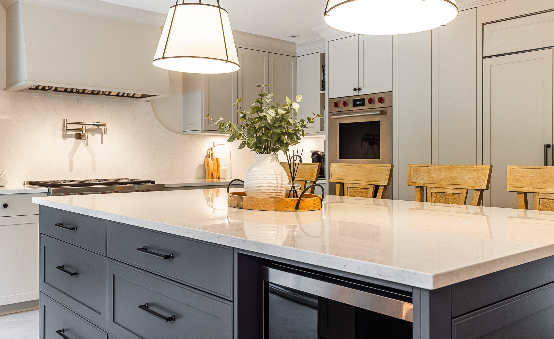 Discover a modern kitchen featuring a sleek white island, dark cabinetry, and warm, natural accents, perfect for cooking and gathering.