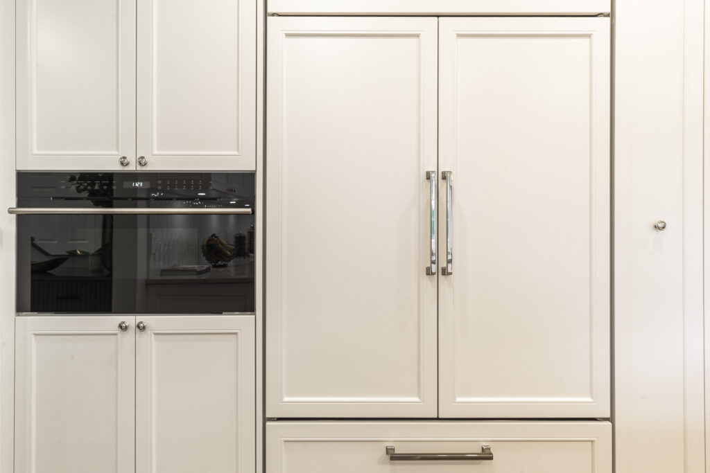 Sleek white modern kitchen with integrated appliances, minimalist design, and elegant storage solutions.
