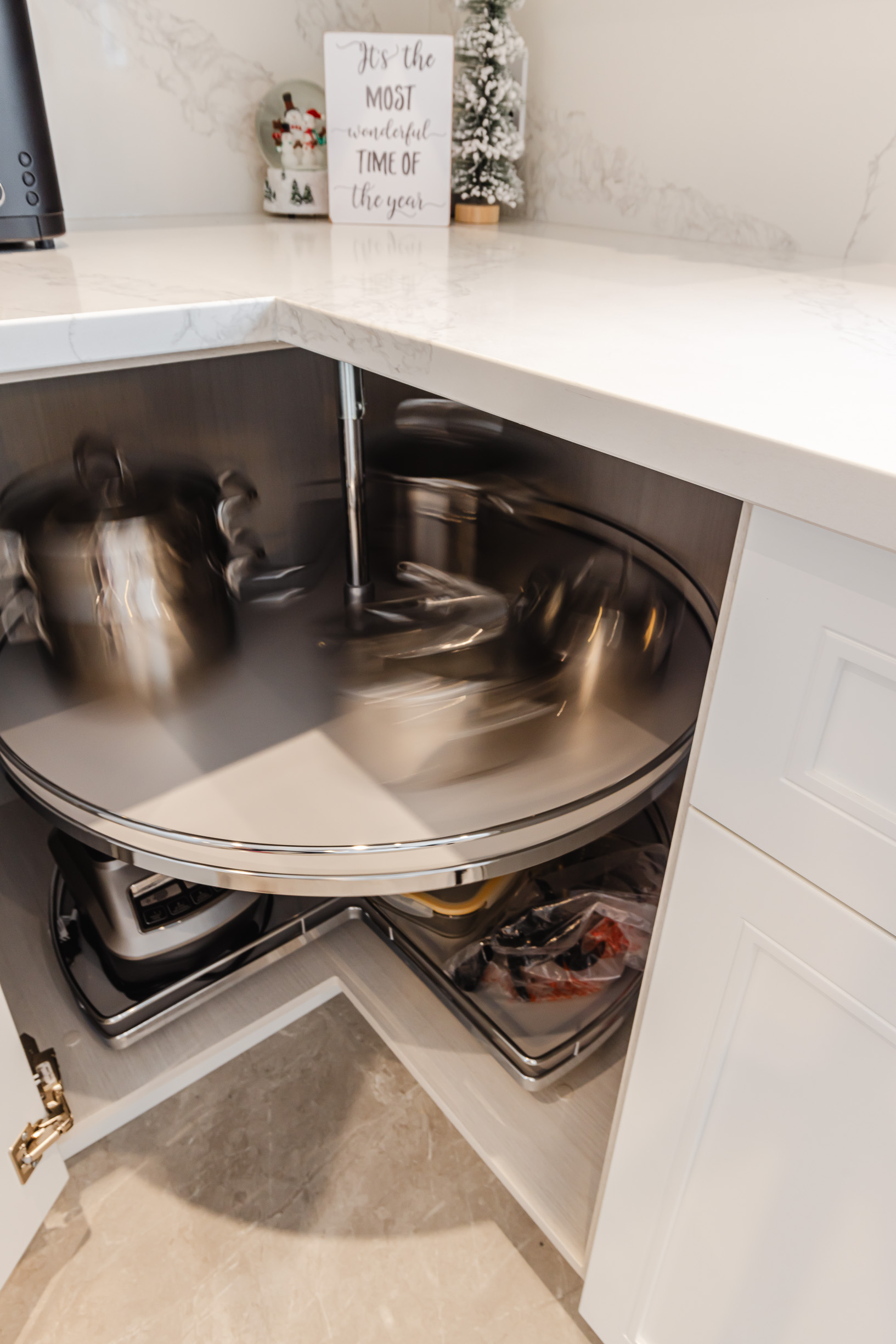 Modern kitchen with corner cabinet and lazy Susan, featuring sleek design and festive decor.