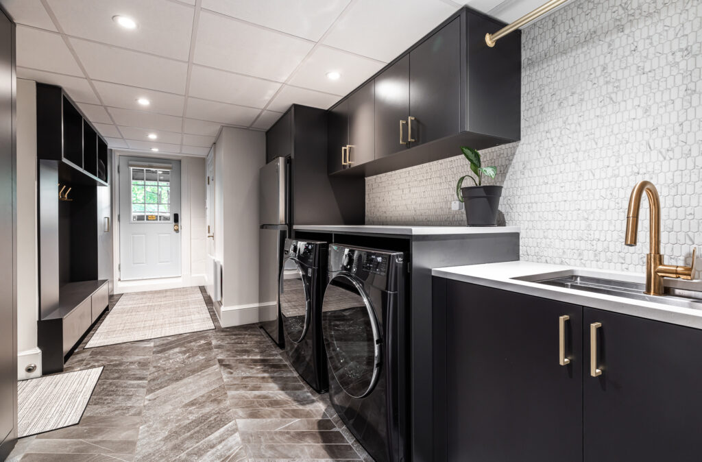 Contemporary laundry room with stylish cabinetry, elegant fixtures, and bright natural light.