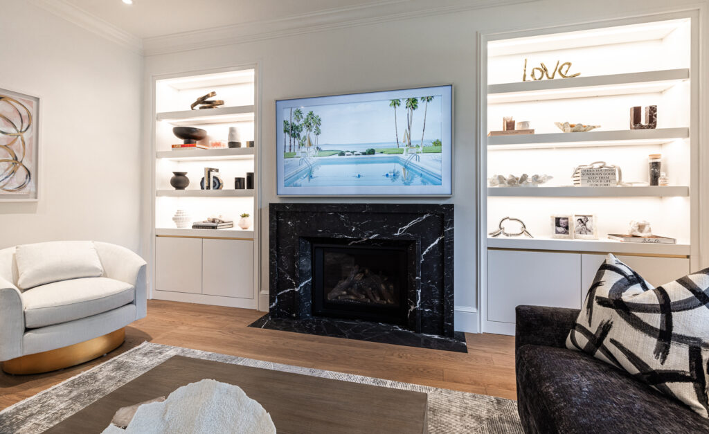 Elegant modern living room with a cozy fireplace, stylish seating, and curated decor.