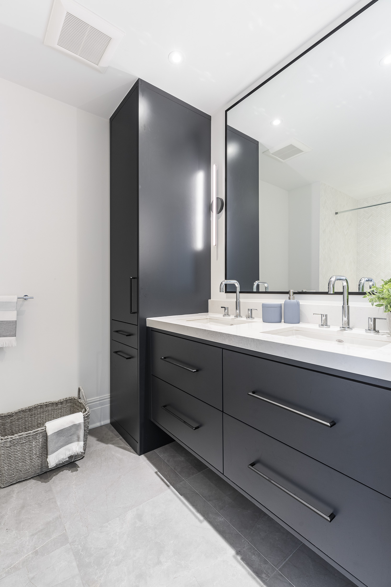 Discover a sleek modern bathroom featuring a stylish double vanity, large mirror, and soothing color palette for a serene ambiance.