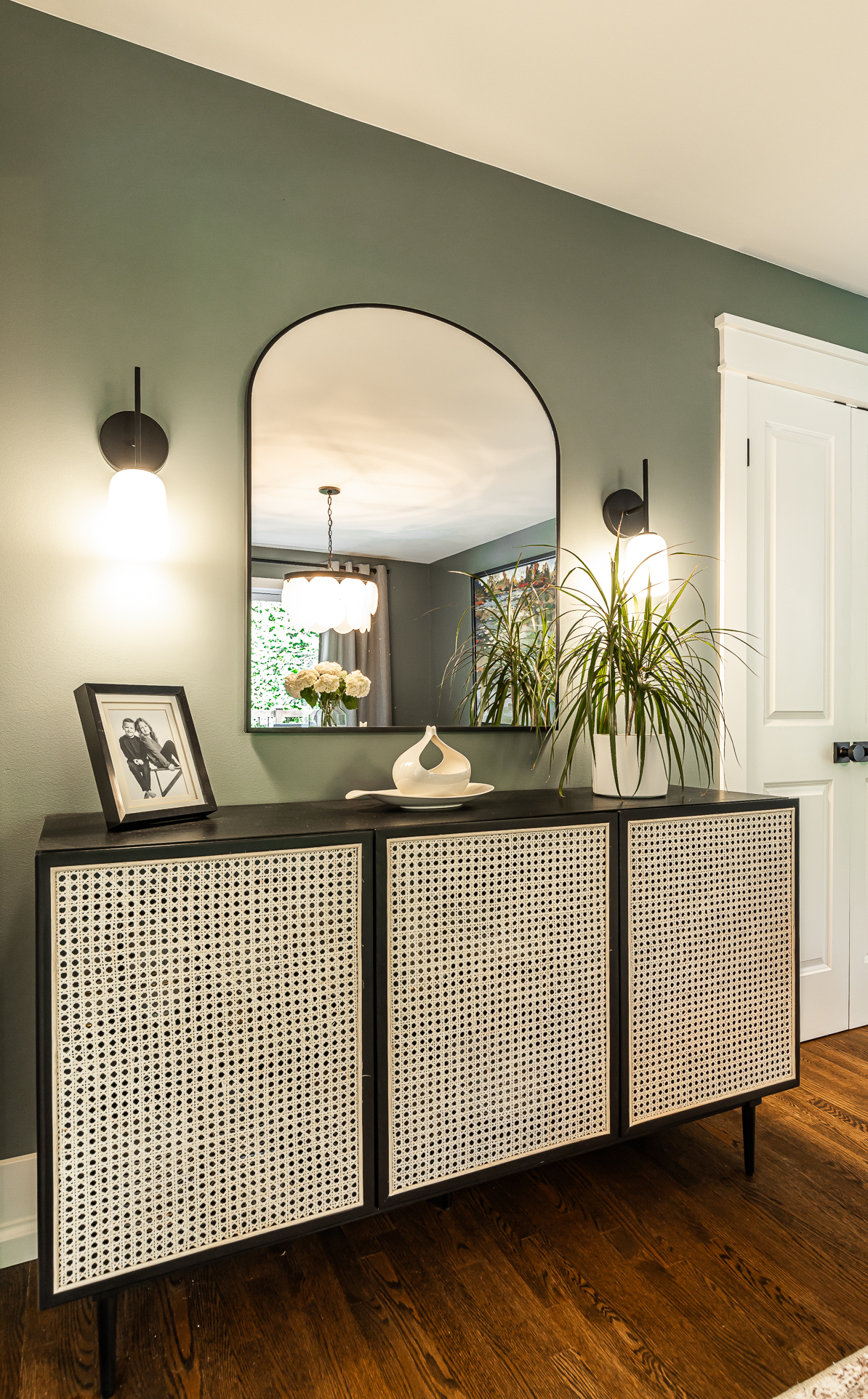 Modern entryway with elegant console table, mirror, and warm lighting inviting guests with style.