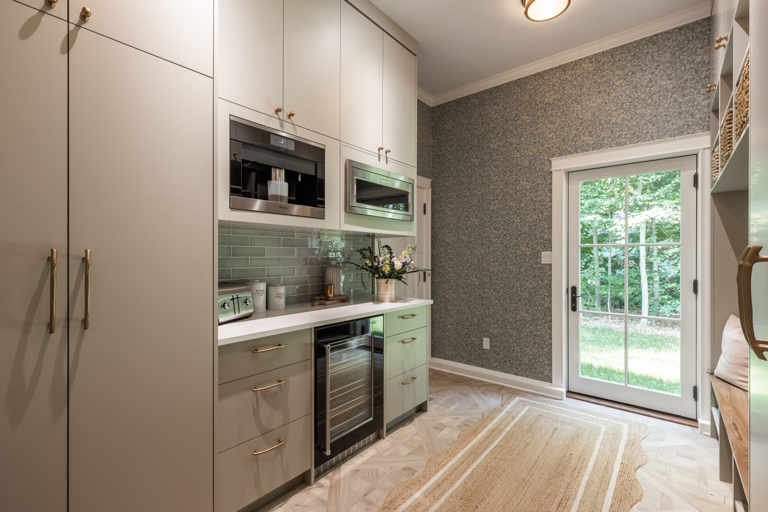 Elegant kitchen with light cabinetry, gold accents, and natural light for a warm, inviting atmosphere.