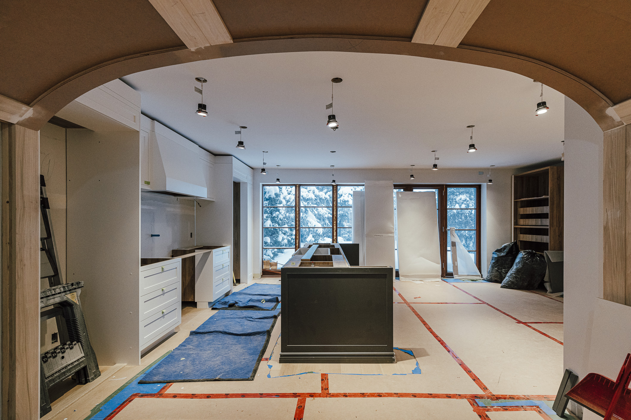Bright and spacious unfinished kitchen featuring modern design elements and ample natural light, poised for renovation completion.