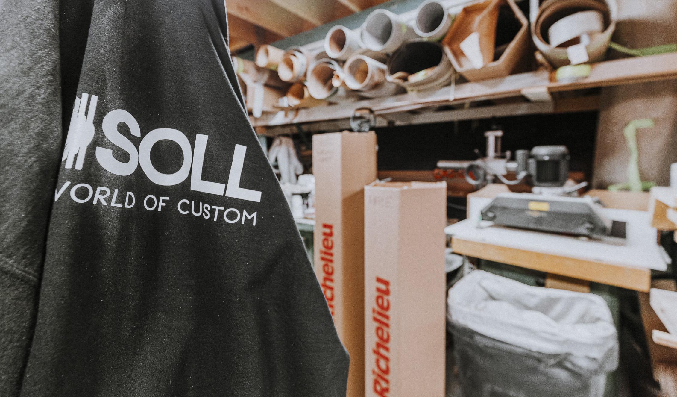 Explore a vibrant custom design workspace featuring the #SOLL garment, organized crafting supplies, and the creative spirit of unique projects.