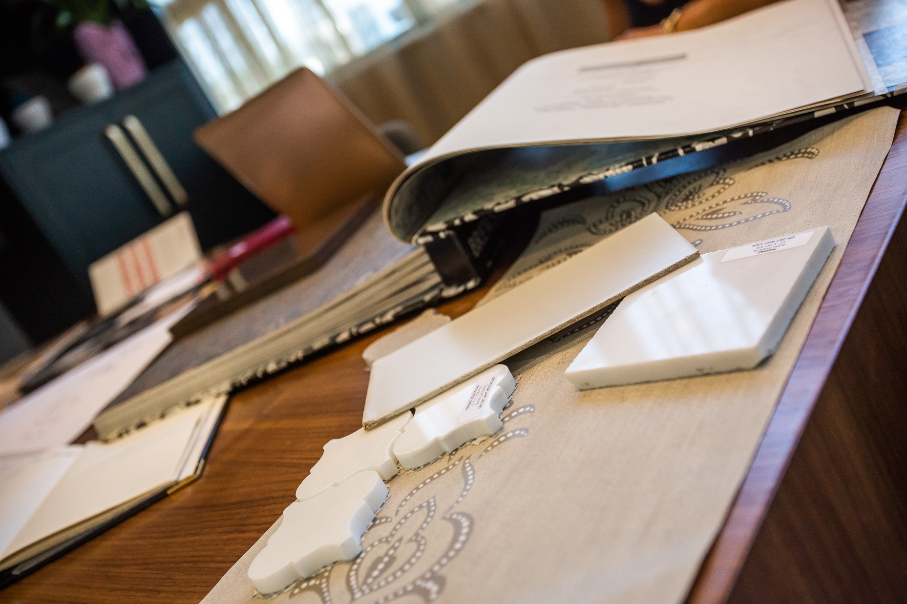 A sophisticated workspace showcases design samples and materials, inviting creativity for interior renovation projects.